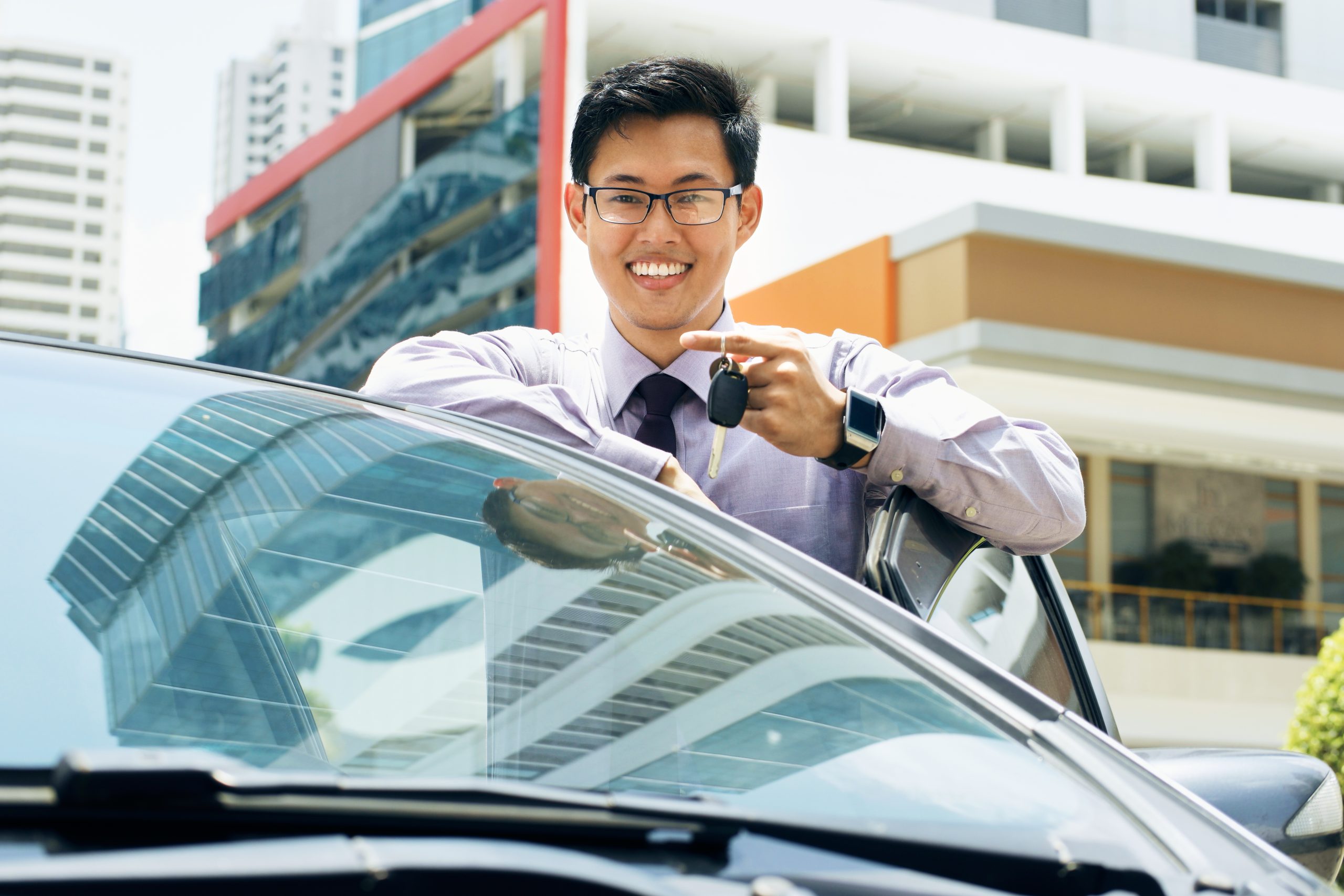 Happy Young Asian Man Smiling Showing Keys Of New Car